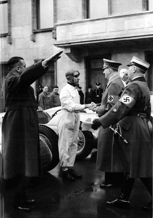 Adolf Hitler greets racing driver Tazio Nuvolari during the International Motor Show in Berlin